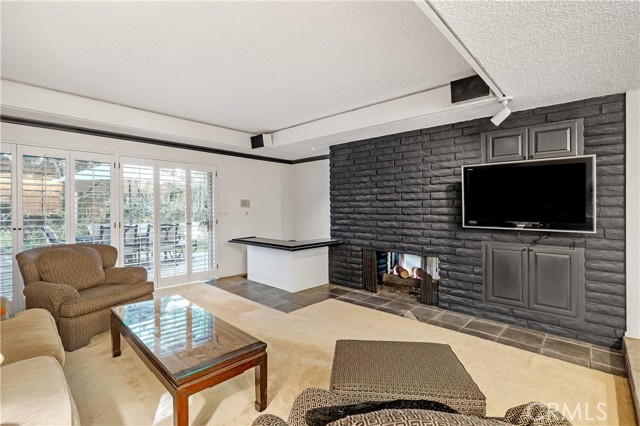 The family room features a beautiful fireplace, wet bar and access to the beautiful backyard.