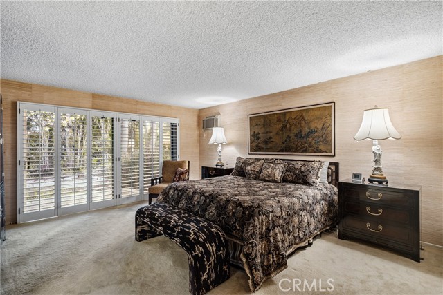 The main bedroom is a large suite with gorgeous views to the beautiful tree and greenery in the backyard garden.