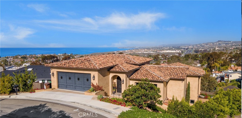 Custom built in 2020 Spectacular Ocean Views, Sunset Views and Spectacular City Light Views! You have it ALL! The interior features 3 spacious bedrooms, Plus Office / Game Room, 5 bathrooms & 3,374sqft of living space. As you enter through the custom iron front door, you are welcomed into the foyer hall, with beautifully laid herringbone hardwood floors and Spanish tile stair raisers. Let the abundance of light and ocean breeze drawl you into the impressive Great Room which boasts soaring 18 foot tall ceilings. The Great Room gives a seamlessly flowing layout that's perfect for entertaining, with it's open kitchen, dining and living room concept. The well-equipped and beautifully designed kitchen will impress even the most discerning home chef! Featuring a Wolf 48" 4 burner duel fuel range, 24" cast iron griddle and double oven, paneled sub zero refrigerator and freezer, built-in Miele coffee system and Miele speed oven, and the 11 foot island are open to the Large dining area that will be great for hosting your next gathering. The living room features a magnificent entertainment zone, with built-in cabinetry, floating shelves and a 7' foot long electric fireplace. Centered in the great room is a 12 foot wide glass bi folding door that leads to a large covered balcony that offers quintessential indoor-outdoor living space with impressive panoramic ocean and city light views in addition to a custom rod iron spiral staircase which leads down to the backyard. The Main floor also hosts the Master Bedroom that features 10' foot ceilings, private balcony, massive 9 foot glass shower, oversized Hydro Systems Jetted Tub and large walk-in closet. Custom wrought iron railing leads you downstairs into a bonus room, this area is perfect for a second family room or game room or spacious home office. The additional two en-suite bedrooms are located on either side of the bonus room. Along with a spacious laundry room and huge storage room. The backyard offers true resort living from the expansive ocean views, covered outdoor patio, outdoor bathroom, 2nd gathering area under a beautifully situated private pergola that houses a Jacuzzi hot tub with spectacular views. Situated on a single-loaded street, ocean and city light views throughout, 18' foot garage door opening, beautiful landscaping, additional outdoor storage room and just minutes away from beaches, restaurants and shopping. Too many amazing features to mention! This special home is unlike any other!