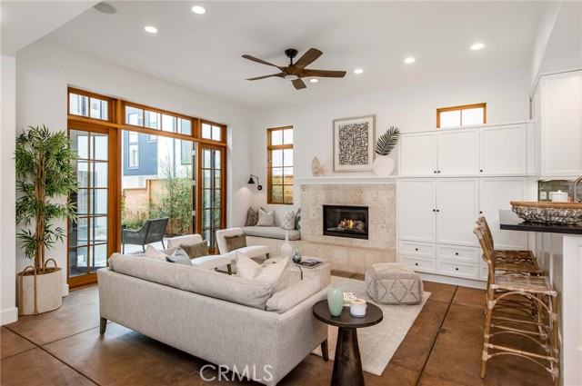 Living room with ultra high ceilings and expansive French doors to courtyard.