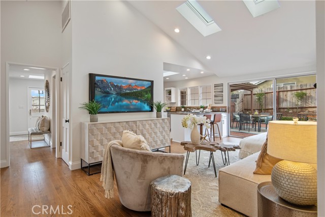 Family room with skylights and vaulted ceiling is open to the kitchen and patio