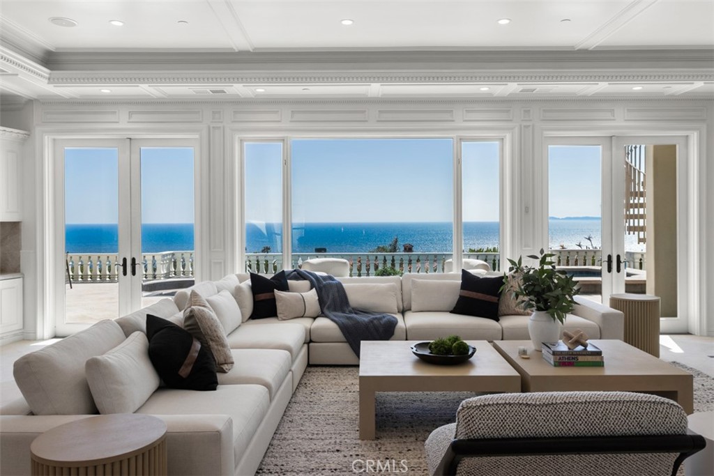Experience unparalleled coastal luxury at this custom estate in the exclusive guard-gated community of Ritz Cove. Perched on an elevated half-acre bluff at the end of a cul-de-sac, this corner residence boasts no neighbor on the south side and offering panoramic vistas of Catalina Island, Salt Creek Beach, and the lush adjacent parkland.

Designed for both grand entertaining and intimate relaxation, the home features five expansive en-suite bedrooms. Notably, two are primary level suites with sweeping ocean views through exceptional picture windows,  and each adorned with a fireplace and private terrace—providing serene retreats that capture the essence of seaside living. All bedrooms are generously sized, with four featuring their own fireplaces and terraces, enhancing the indoor-outdoor lifestyle.

The recently upgraded chef’s kitchen is a culinary masterpiece, equipped with Taj Mahal quartzite countertops, custom cabinetry, and top-of-the-line Sub-Zero and Wolf appliances. Floor-to-ceiling windows throughout the home flood the interiors with natural light and frame the breathtaking coastal scenery.

Additional highlights include a grand two-story foyer, a wood-paneled study, a formal living and dining room, and an upstairs lounge with a fully equipped bar. The outdoor oasis is complete with a resort-style pool and spa, outdoor fire features, and a built-in cook center—perfect for entertaining against the backdrop of the Pacific Ocean.

Situated between the renowned Ritz-Carlton and Waldorf Astoria resorts, and just moments from Monarch Beach Golf Links, this estate offers direct gated access to the beach trail, placing the sand and surf just steps from your backyard.