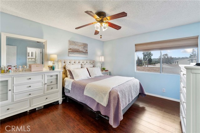 Upstairs larger room with ceiling fan, blinds that open from top or bottom, laminate flooring and has direct access to the full bath, walk in closet and mirrored closet doors. Plenty of room to store your clothing needs.