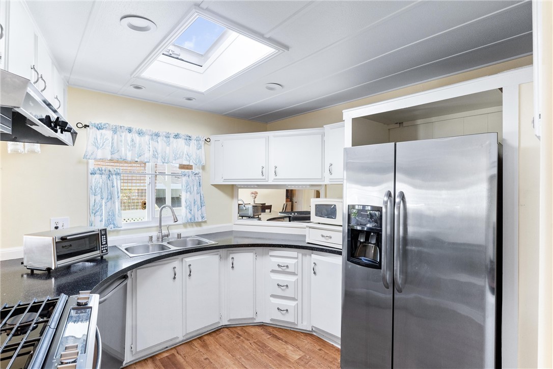 upgraded kitchen featuring plenty of counter space and skylight