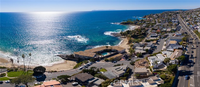 631 Cliff Drive A16 Laguna Beach, California A Rare Oceanfront Residence in Laguna Beach. Experience the pinnacle of oceanfront living in this exceptionally rare residence dramatically set above the water in beautiful Laguna Beach. Step inside to find an immaculately maintained home with wood flooring, custom fixtures, and beaming 180 ocean views from every corner of the interior. The updated chef’s kitchen is ideal for the culinary adventurer and features farmhouse sink, custom wood cabinetry, and top-tier stainless steel appliances. Indulge in endless ocean, island, and sunset views in the sitting room with expansive folding doors providing the quintessential indoor/outdoor lifestyle. Breathe-in the dewy sea breeze each morning in the spacious primary suite with hand-carved barn doors, walk-in shower, and glass sliders opening to the private oceanfront balcony, perfect for daily reflection or evening refreshments. A media room provides a relaxing space for entertaining and includes custom wood shelving and designer wallpaper. The iconic residential community of 631 Cliff Dr. also offers residents a pool, additional storage space, and exclusive access to Fisherman’s Cove. Located just steps from the beach, as well as the fine dining, entertainment, and retail of Laguna, this seaside home offers year-round, resort-inspired living combined with an unparalleled oceanfront lifestyle experience.