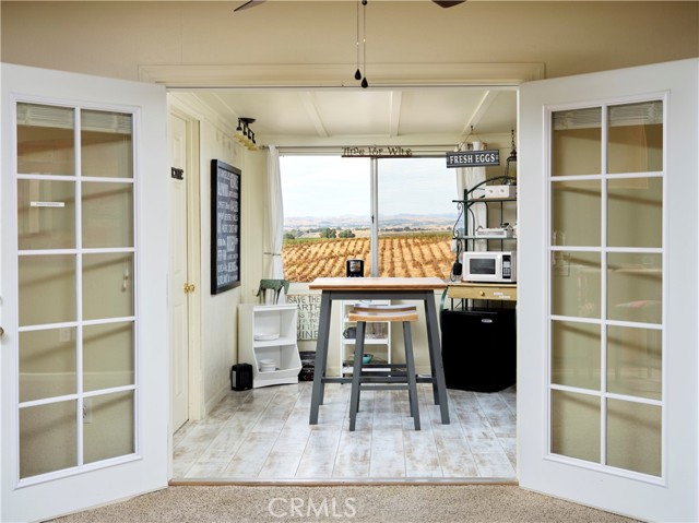 French doors from dining area open to enclosed porch and entrance to Air BnB