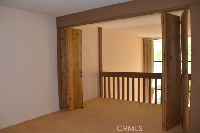 Primary bedroom opens to balcony extension.