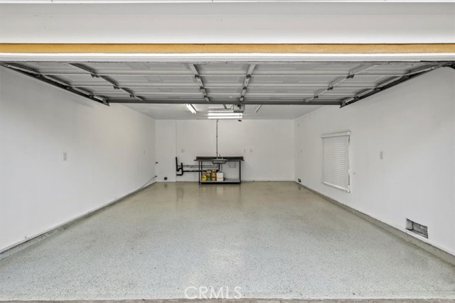 Epoxy coated garage floor. There is a wash basin in garage + 2nd set of laundry hook-ups. The primary laundry is inside house in a dedicated laundry area.