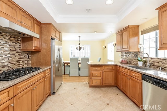 Kitchen w/Quartz counters, Porcelain Tile Flooring, glass back splash, recessed lighting and self closing cabinet hardware