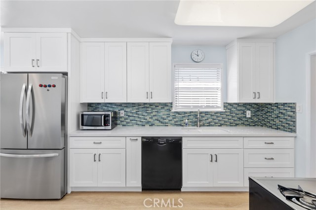 Remodeled kitchen with white cabinetry and built-ins