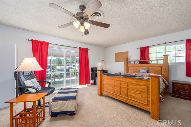 Fifth Bedroom with ceiling fan and carpet