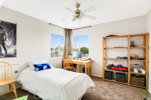 Corner French-glass windows provide an overlooking view of the neighborhood on this 2nd Floor Bedroom.