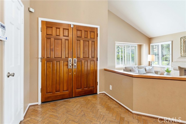 Formal living room with cathedral ceilings, double pane windows and fireplace.