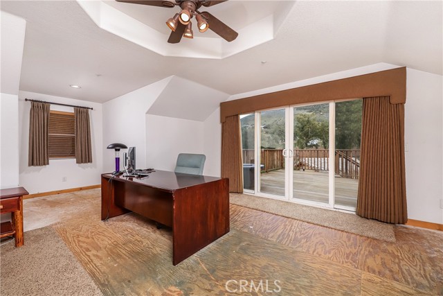 Primary bedroom with enough space for your office and slider to deck with access to the pool.