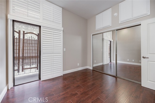 Bedroom 2, with floor to ceiling glass (slider and window)