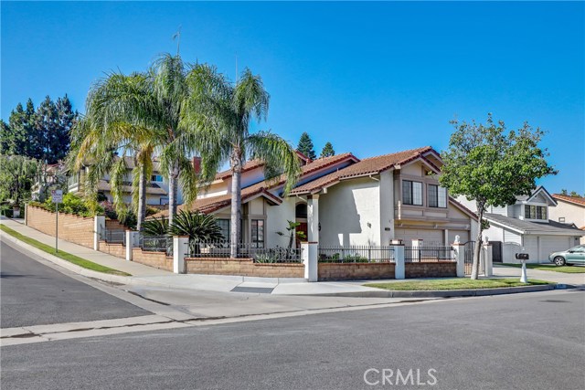 5638 E Elsinore Ave Orange, California Beautiful pool home located on a premium corner lot in Orange. Open Floor Plan with Custom shutters, LED recessed lighting and vaulted ceilings throughout the home. Enter into the inviting living room that seamlessly flows to the formal dining room. The adjacent kitchen features a breakfast bar and opens to the breakfast nook. Step down to the family room featuring warm wood laminate floors, built-in shelves, a cozy brick fireplace, sliding doors to the beautiful backyard and a wet bar. A full bathroom completes the downstairs. Upstairs, the huge master suite boasts vaulted ceilings, a retreat area with a cozy brick fireplace and an en-suite master bathroom with dual sinks, soaking tub and a walk-in shower. Down the hall, three additional bedrooms are generously sized and share the full hall bathroom with dual sinks. A convenient three-car attached garage with lots of storage. Spacious and private backyard featuring a sparkling salt water pool and spa that has been recently redone with covered patio.