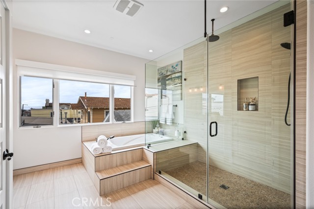 Large walk-in shower and modern soaking tub.
