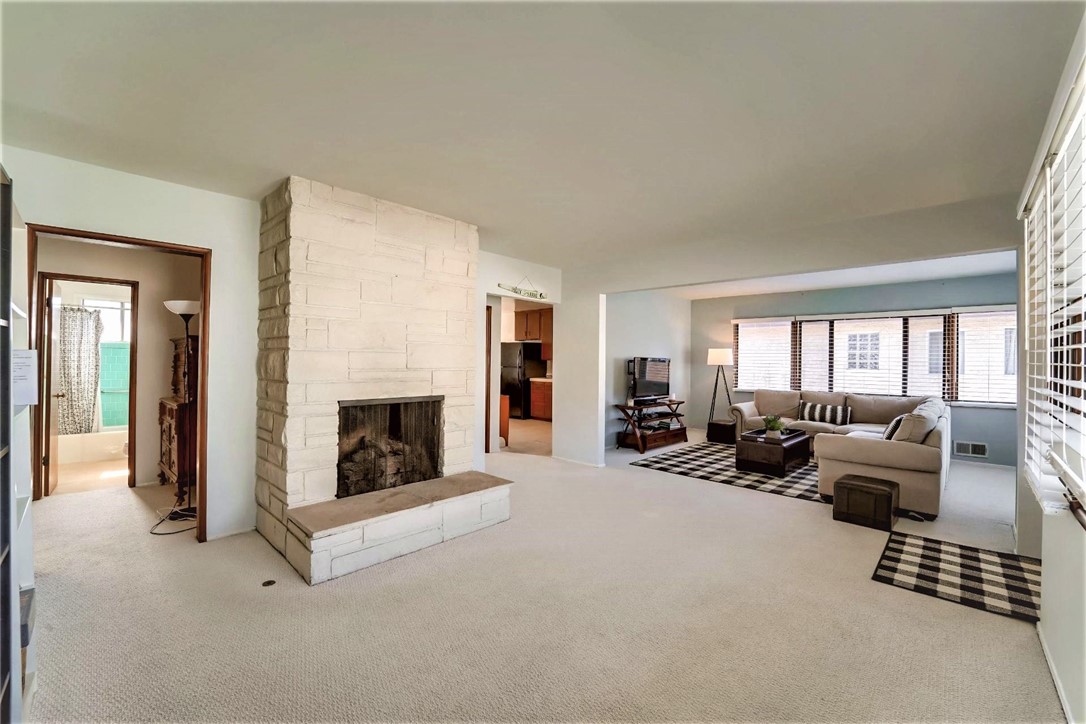 The entry to the left of the family room opens to the full bath and 2 of the bedrooms and the entry to the right opens to the kitchen. There is a stairway in the kitchen which leads down to the lower level.