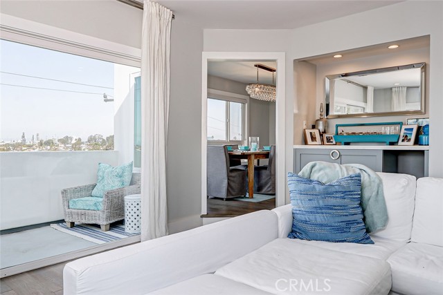 The living room opens to a viewing deck overlooking the rear yard plus an ocean glimpse