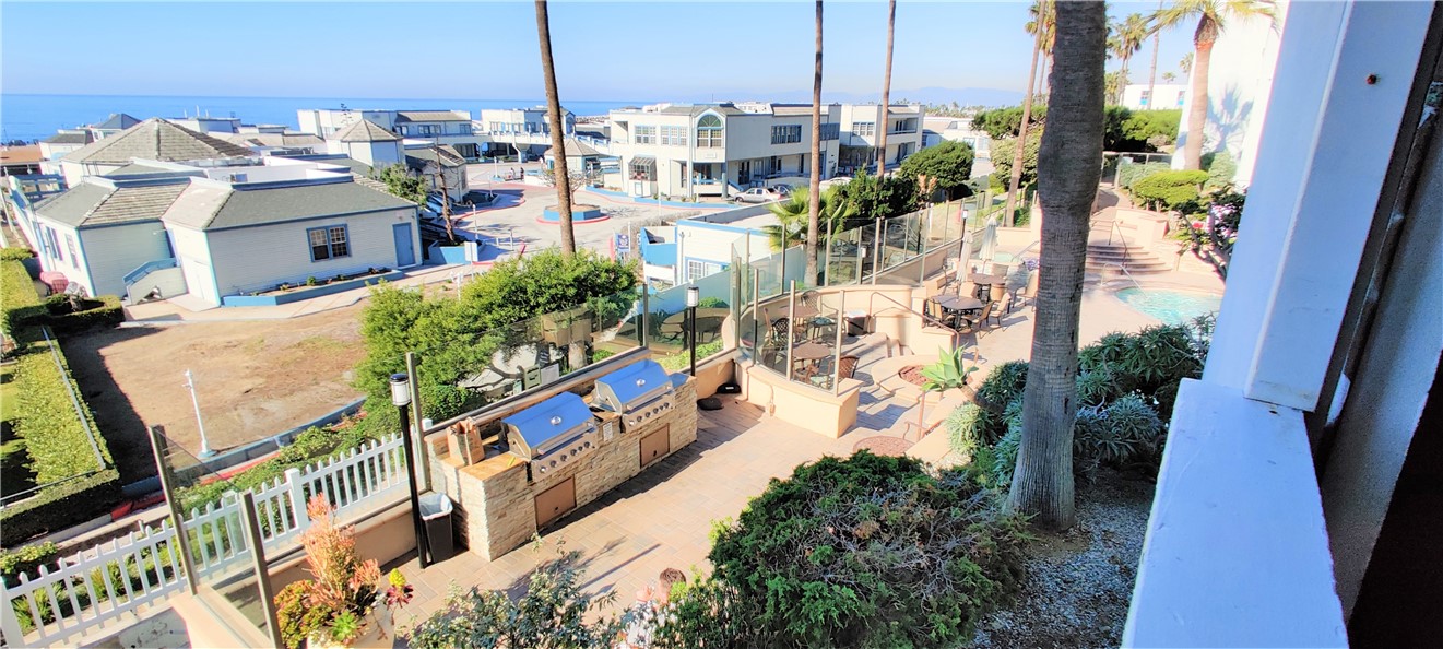 View of pier and BBQ and pool/spa area.