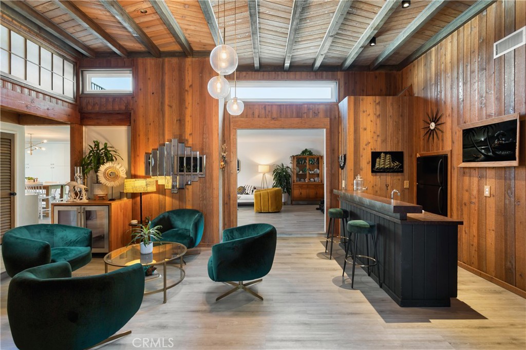 A soulful space where architecture meets atmosphere, wrapped in intention, design, and detail. 33252 Big Sur is a rare coastal offering that effortlessly blends mid-century character with design-driven upgrades, inviting a slower, more intentional way of living just minutes from the ocean. Set behind privacy walls on an oversized corner lot in the coveted Dana Knolls community of Dana Point, this 4-bedroom, 3-bath retreat feels curated more than constructed, layered with craftsmanship, texture, and unexpected moments throughout. Inside, the layout unfolds with quiet confidence. Original doors and warm wood paneling line the walls. Vintage hand-laid tile in the baths offers a nod to the home’s architectural roots. Natural transitions between living, dining, and outdoor spaces create a flow that feels both intuitive and intentional. Black-trimmed windows frame lush landscaping, and custom lighting adapts with the rhythm of the day. The kitchen, anchored by Café appliances, lacquered cabinetry, and a handcrafted island, blends form and function without disrupting the surrounding calm. 3 bedrooms and two 2 bathrooms are located on the main level, offering flexibility for guests, remote work, or multigenerational living. The entire second floor is dedicated to the primary suite, where custom built-ins, a private ensuite, and access to an expansive view deck create space for sunrise coffee, mid-day lounging, or stargazing beneath the coastal sky. Outdoors, the experience continues. A recently upgraded and updated pool and spa are surrounded by tropical landscaping, Alumawood-covered patios, and curated hardscape. A floating bridge leads to a firepit lounge tucked behind the privacy walls, while a full outdoor bathroom and shower add ease to poolside days and post-beach living. As the sun sets, the entire yard glows, designed not just for entertaining, but for everyday enjoyment. Additional highlights include a three-car garage with epoxy floors, gated parking for an RV or boat, and system upgrades throughout including roof, HVAC, plumbing, windows, and electrical. Located minutes from world-class beaches, the Lantern District, and the long-awaited Dana Point Harbor revitalization, this is more than a home. It is a design-forward retreat with scale, soul, and story. Built with intention. Brought back to life with care. And now ready to carry YOUR story forward...a home with warmth, rhythm, and soul, ready for whatever comes next.
