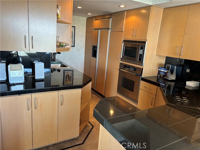 Kitchen with black granite counters