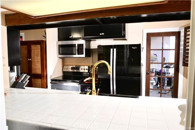 Galley kitchen showing the pass-through to the breakfast dining area.