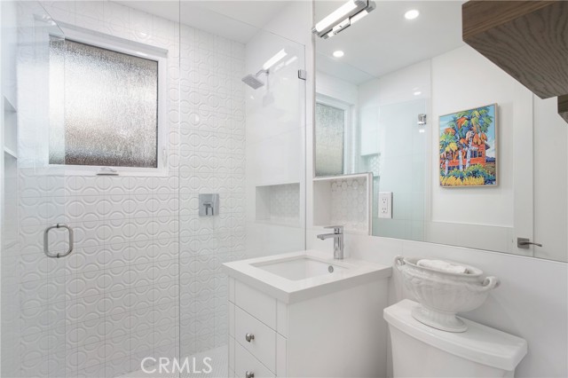 Designer bath with floating vanity in rear unit