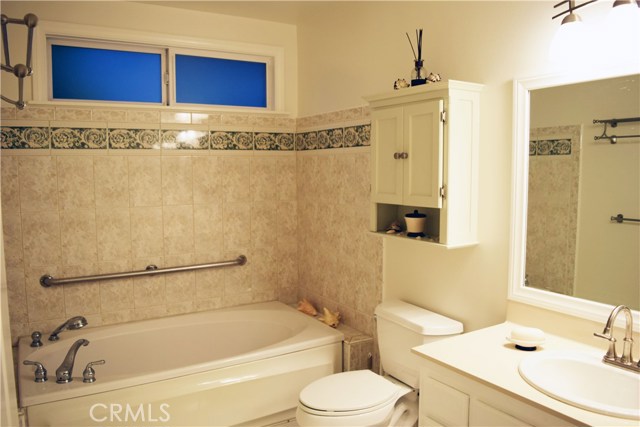 soaking tub with shower handle in master bathroom