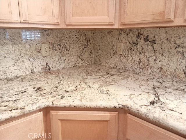 Gorgeous granite counter tops with rotating shelves on the bottom corner cabinets