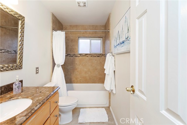 Hallway Bathroom - The tile work in the shower pairs beautifully with the vanity and mirror.