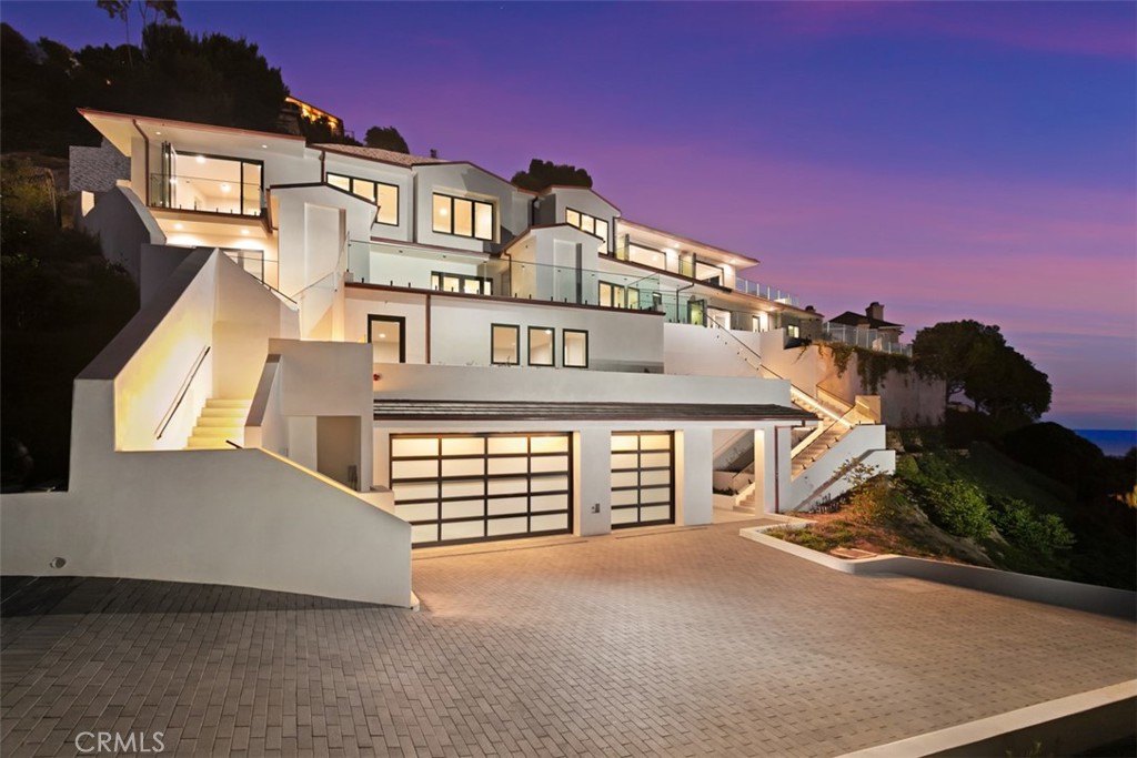 Introducing one of the most spectacular brand-new construction offerings in all of Laguna Beach — a striking contemporary estate nestled within the ultra-exclusive guard-gated enclave of Three Arch Bay. Perched on a nearly 28,500 square foot lot, this architectural triumph offers 5,223 square feet of open-concept living space, breathtaking panoramic ocean views, and a level of privacy rarely found on the coast. A true seven-year labor of love, this estate stands as a testament to vision, patience, and craftsmanship. Engineered around a massive retaining wall and constructed to the highest standards, this is a build that may never be replicated or seen again in coastal Orange County. A long, private driveway leads to a stunning multi-level facade wrapped in crisp white modern lines and expansive glass. Inside, walls of glass seamlessly disappear to merge indoor-outdoor living, unveiling sweeping views of Catalina Island and the Pacific. The chef’s kitchen features top-tier appliances, and a massive island ideal for entertaining. Step outside to expansive view terraces, a built-in outdoor kitchen, and a pristine spa that invites relaxation with the ocean as your backdrop. Two generous bonus rooms offer flexible space for a gym, office, or media room, while spa-like bathrooms include ocean-view soaking tubs and an oversized steam shower. Crafted with meticulous attention to detail and designed for the most discerning buyer, this rare offering represents the pinnacle of coastal luxury and a once-in-a-lifetime opportunity to own a statement property in one of California’s most prestigious oceanfront communities. Residents enjoy exclusive access to a private beach with natural tide pools and dramatic coastal arches, along with community amenities including tennis courts, a clubhouse, and 24/7 security. Perfectly positioned just minutes from downtown Laguna Beach, world-class resorts, fine dining, and top-rated schools, Three Arch Bay is one of Southern California’s most sought-after coastal communities — where privacy, luxury, and natural beauty converge. Introducing one of the most spectacular brand-new construction offerings in all of Laguna Beach — a striking contemporary estate nestled within the ultra-exclusive guard-gated enclave of Three Arch Bay. Perched on a nearly 28,500 square foot lot, this architectural triumph offers 5,223 square feet of open-concept living space, breathtaking panoramic ocean views, and a level of privacy rarely found on the coast. A true seven-year labor of love, this estate stands as a testament to vision, patience, and craftsmanship. Engineered around a massive retaining wall and constructed to the highest standards, this is a build that may never be replicated or seen again in coastal Orange County. A long, private driveway leads to a stunning multi-level facade wrapped in crisp white modern lines and expansive glass. Inside, walls of glass seamlessly disappear to merge indoor-outdoor living, unveiling sweeping views of Catalina Island and the Pacific. The chef’s kitchen features top-tier appliances, and a massive island ideal for entertaining. Step outside to expansive view terraces, a built-in outdoor kitchen, and a pristine spa that invites relaxation with the ocean as your backdrop. Two generous bonus rooms offer flexible space for a gym, office, or media room, while spa-like bathrooms include ocean-view soaking tubs and an oversized steam shower. Crafted with meticulous attention to detail and designed for the most discerning buyer, this rare offering represents the pinnacle of coastal luxury and a once-in-a-lifetime opportunity to own a statement property in one of California’s most prestigious oceanfront communities. Residents enjoy exclusive access to a private beach with natural tide pools and dramatic coastal arches, along with community amenities including tennis courts, a clubhouse, and 24/7 security. Perfectly positioned just minutes from downtown Laguna Beach, world-class resorts, fine dining, and top-rated schools, Three Arch Bay is one of Southern California’s most sought-after coastal communities — where privacy, luxury, and natural beauty converge.