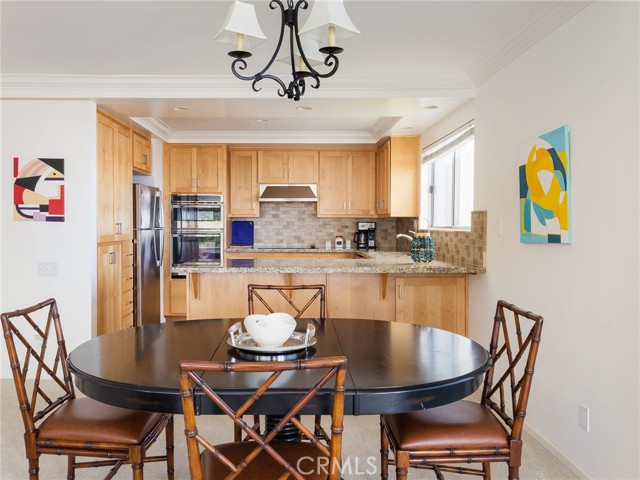 Beautiful maple cabinets, granite counters, stainless steel appliances, adjacent dining area - gracious living.