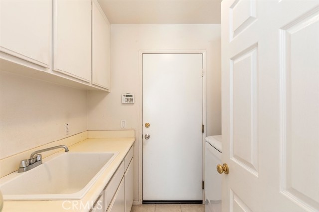 The laundry room conveniently connects to the garage for easy access.