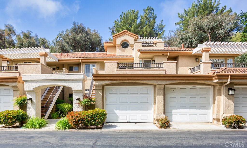 Beautifully Updated Upper-Level Condo in Gated Las Ventanas Community! Welcome to this move-in ready 2-bedroom + loft, 2-bathroom condo located in a prime location of Valencia. Full of natural light and modern upgrades, this stylish home features vaulted ceilings in the living room, a striking floor-to-ceiling custom stone fireplace, and a spiral staircase that leads to a spacious loft with an office nook—perfect for working from home or relaxing. The kitchen thoughtfully designed with granite countertops, glass-front cabinetry, stainless steel appliances, and recessed lighting. Both bathrooms have been tastefully upgraded with granite countertops and quality finishes. The primary suite offers custom built-ins in the closet and access to one of 3 oversized balconies. Additional features include plantation shutters, an in-unit laundry closet, and a 1-car garage plus 1 carport space. Las Ventanas is a well-maintained community offering a pool and spa and is conveniently located near Valencia’s paseo trail system for hiking, biking, and leisurely strolls. Just across from Granary Square and minutes from Westfield Valencia Town Center, top-rated schools, College of the Canyons, CalArts, Henry Mayo Hospital, and the 5 freeway. Don’t miss the opportunity to own this upgraded, light-filled condo in one of Valencia’s most sought-after neighborhoods!