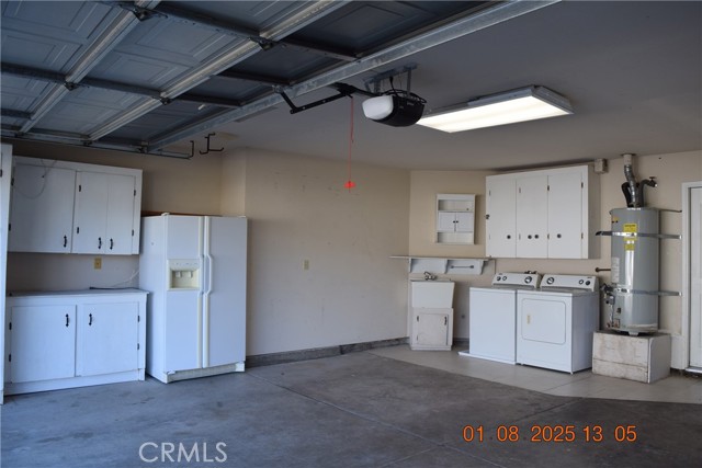 Garage with Washer /Dryer, working refrigerator and wash sink.