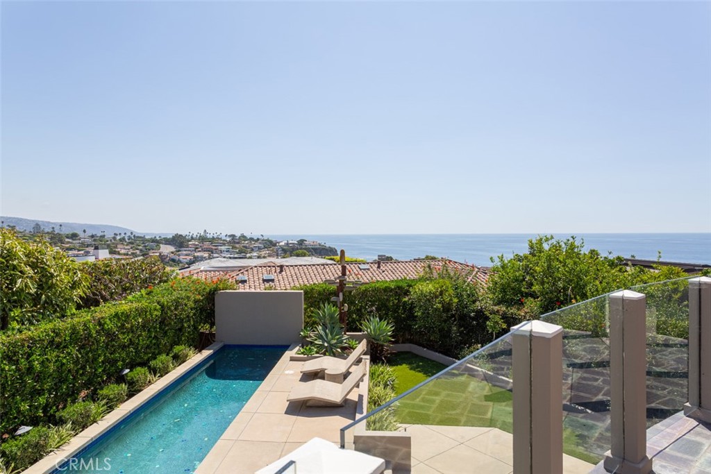 EMERALD BAY - LAGUNA BEACH - One of the finest single-family residences in the exclusive private beach community of Emerald Bay. This Emerald Bay property checks all of the boxes. New hillside location, ocean views, oversized 10,500 square foot lot, two private yards, one with a swimming pool, the other with a large deck adjacent to a grass yard, a built-in bar-b-que with an outdoor dining area. The interior is designed with 5 Bedrooms, 3.5 bathrooms, a large eat-in kitchen, a walk-in pantry, a separate dining room, a main floor family room with a wet bar, and direct access to an oversized garage with separate indoor storage and laundry rooms. All bedrooms are upstairs on the second level with four bedrooms and bathrooms separated from the primary bedroom suite by an upstairs bonus room with a media center, fireplace, and ocean views. The primary bedroom has an outdoor view terrace, a fireplace, a spacious walk-in closet, dual sinks, and commodes.  This soft contemporary Emerald Bay residence is located at the end of a cul de sac not too high up the New Hill, within easy walking distance to all of Emerald Bay's community amenities.
