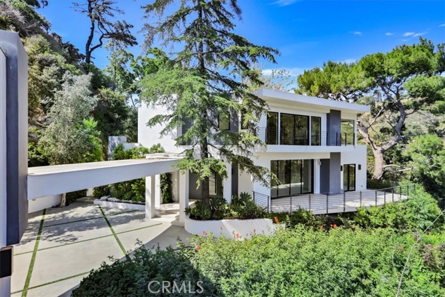 This beautiful, newly renovated modern, smart home with 360 degree views, is situated on nearly an acre lot above the magic and serenity of Hollywood Hills, overlooking Nichols Canyon.  A gated private driveway is leading you to the main house with bright, airy and open living spaces, large balconies with views of the mountain and natural surroundings.  The main house consists of 2 bedrooms on the ground floor, the surround sound movie theater, large and open kitchen, a master suite and a guest suit upstairs, backyard with large pool, outdoor tv area, a lounging sun deck for your and your family to enjoy the natural surroundings.  The detached guest house can be used as a private retreat or could be transformed it into a work space of private gym.  Must See!