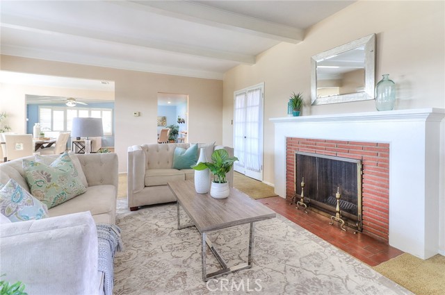 A large Livingroom with a fireplace and French doors that to a screened in porch.