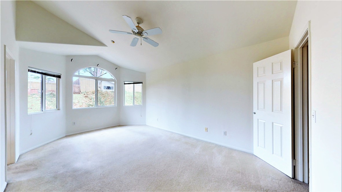 Primary Bedroom with high ceilings, ceiling fan, and lots of light!