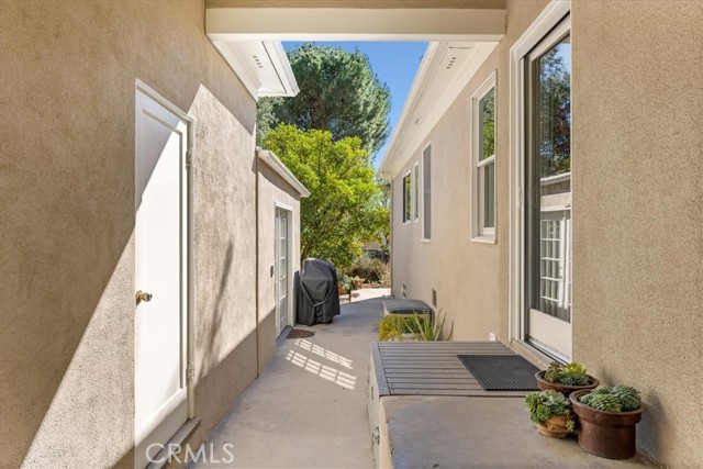 Breezeway to back yard. Garage door on left, kitchen door on right, separate studio access behind garage