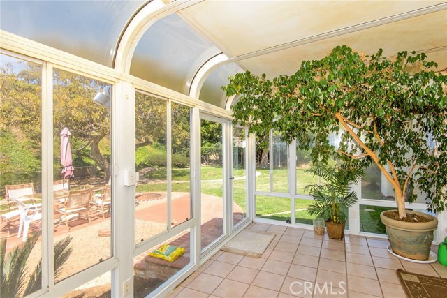 Sunroom/enclosed patio looking into the backyard