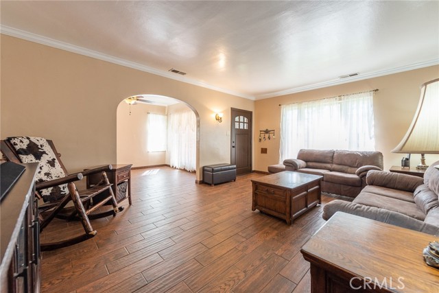 Living room facing front windows with dining room on left