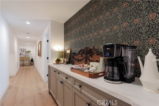 The beverage center with built-in beverage cooler sits just outside the primary suite bedroom. Your morning coffee is at your fingertips! The entire family will enjoy this feature!