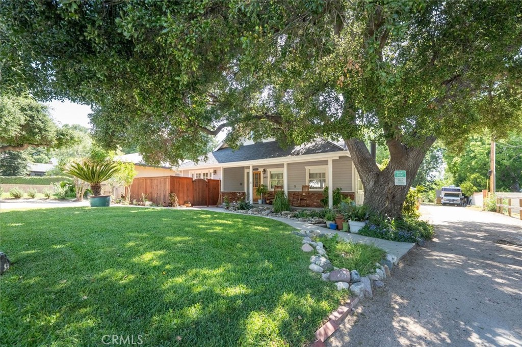 Highly sought after Home in Happy Valley with a guest house!  House is older and full of charm and has been updated throughout, with the solid hardwood floors, tile in bathrooms and kitchen.  The roof on the main house is 7 years old, and the newer HVAC system was put in 6 years ago with completely new ducting.  Guest house in the back is two bedrooms, one full bathroom, large kitchen and laundry area, and access to a private courtyard off the living room with a good size storage shed.  Oversized 2 car garage has room for 2 cars and in addition there is a work space that is 1/3 the total garage space. The yards have been well maintained and there is even an orchard and garden area with raised beds.  
Bring the whole family to see this.  Great neighborhood!  Don't miss out.