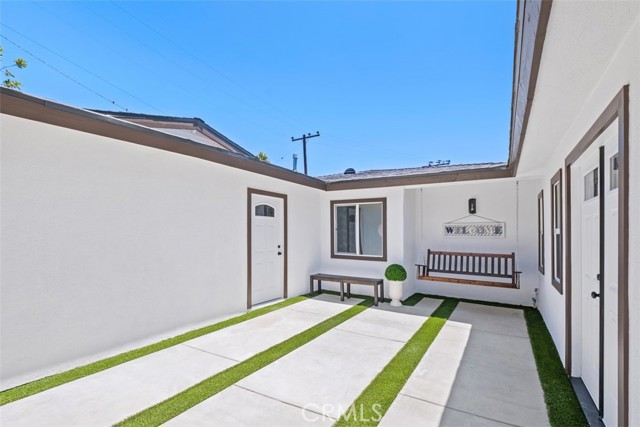 Main entrance to the right, garage door to the left.
