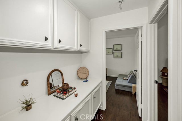 View of hallway with built-in cabinetry and bedroom #2.  Primary bedroom is located on the Right of the photo