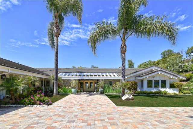 62 E Crest Road E Rolling Hills, California Set in the prestigious gated community of Rolling Hills, awaits this stunning contemporary estate w/an expansive yard surrounded by views. Enter & be mesmerized by grand French doors accentuating nearly every space for seamless indoor/outdoor living. A gourmet kitchen boasts extensive cabinetry for storage, granite counters & enormous center island. At day's end, retreat to the luxurious master suite featuring a decadent sitting area with fireplace, high ceilings and separate master baths w/ soaker tub, vanity sink, & walk in closets. From intimate dinners to lavish parties, cherish your grand patio with sparkling pool & spa surrounded by beautiful greenery & enchanting views. Additional home amenities include a formal living room w/ fireplace, dining room, casual living space w/ bar, extensive guest rooms, attached guest house, office, built-ins & more. An incredible opportunity to live "Behind the gates" move-in & relish your premier location on Crest Road. Classic design and contemporary conveniences in this grand home with a distinguished motor court leading to a 4 car garage and accessed via a long private gated driveway with fountains, manicured landscaping, and that feeling of you have arrived at a very special home. There is also a 4 stall barn, many fruit trees, large flat lawn areas, a dog kennel and solar panels a plenty! This spectacular estate is the perfect property for high end social distancing! Owner can get creative with financing too.