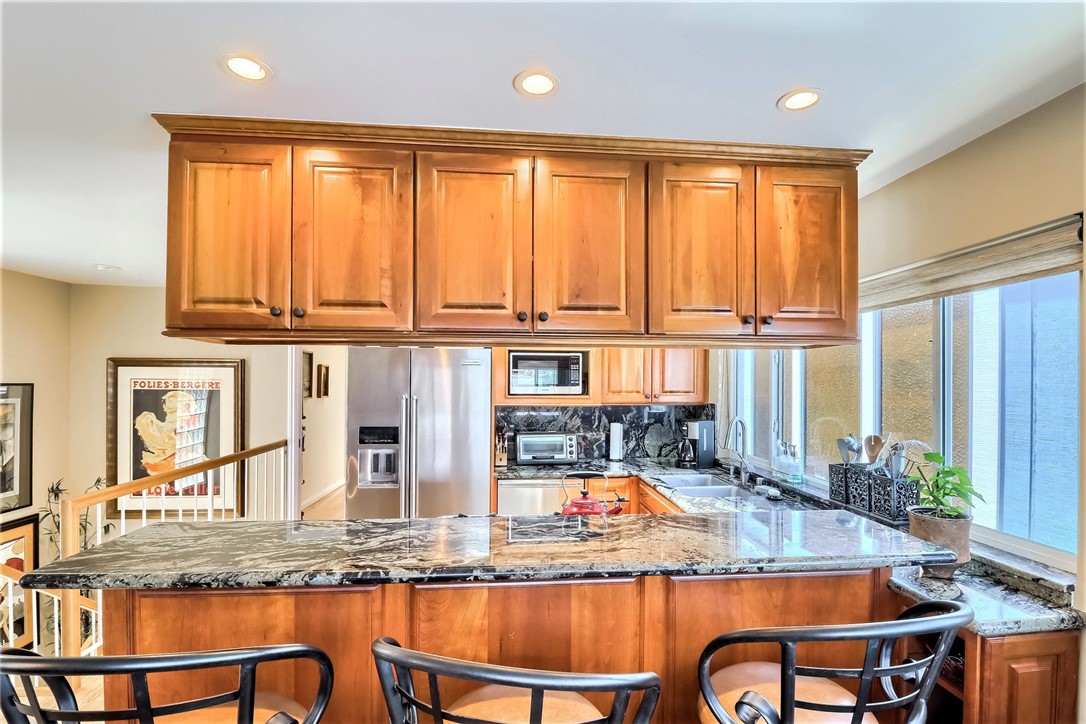 The Remodeled and Upgraded Kitchen has a Breakfast Bar Counter Adjoining the Living Room.
