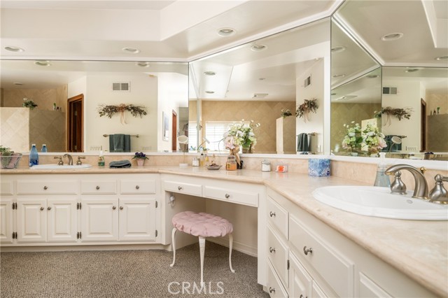 Luxurious Primary Bathroom with Dual Vanities and Makeup Station